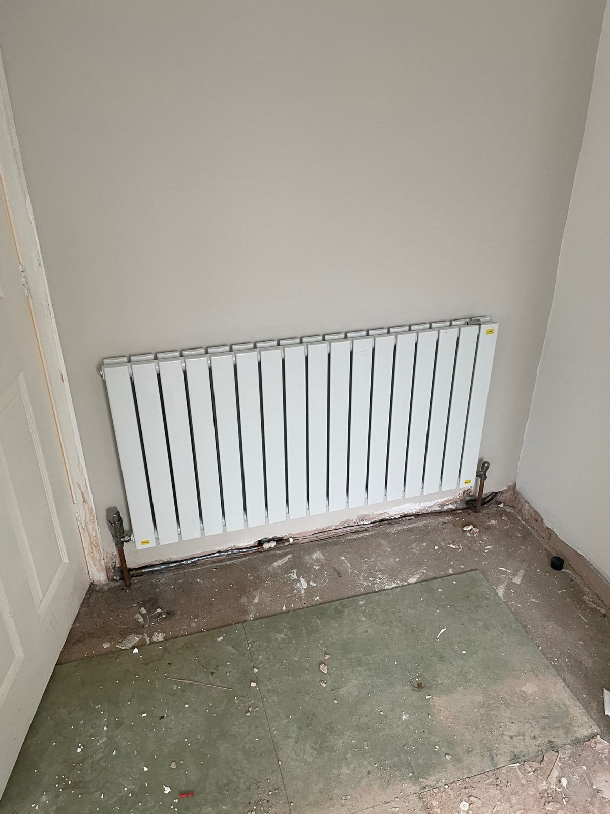 New vertical flat-panel radiator installation on prepared wall, Coventry