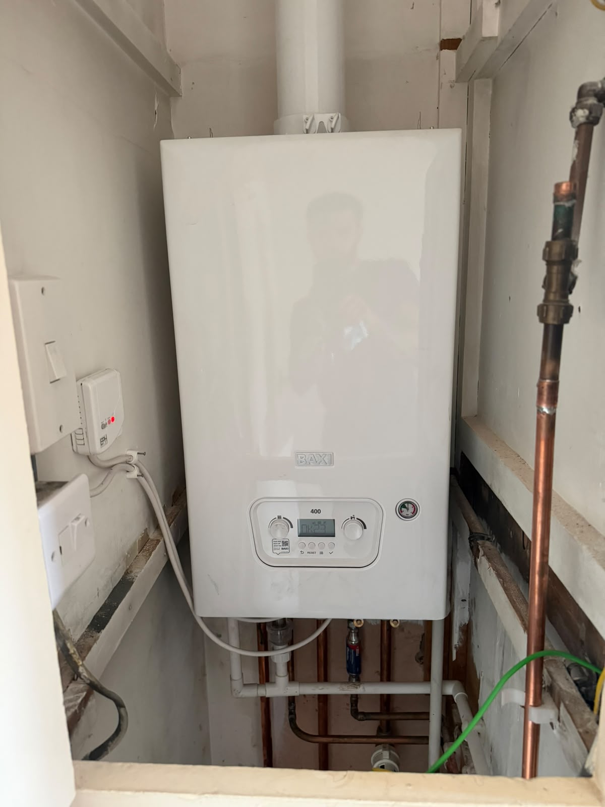 Newly installed Baxi 400 combi boiler with copper pipework in airing cupboard, Coventry