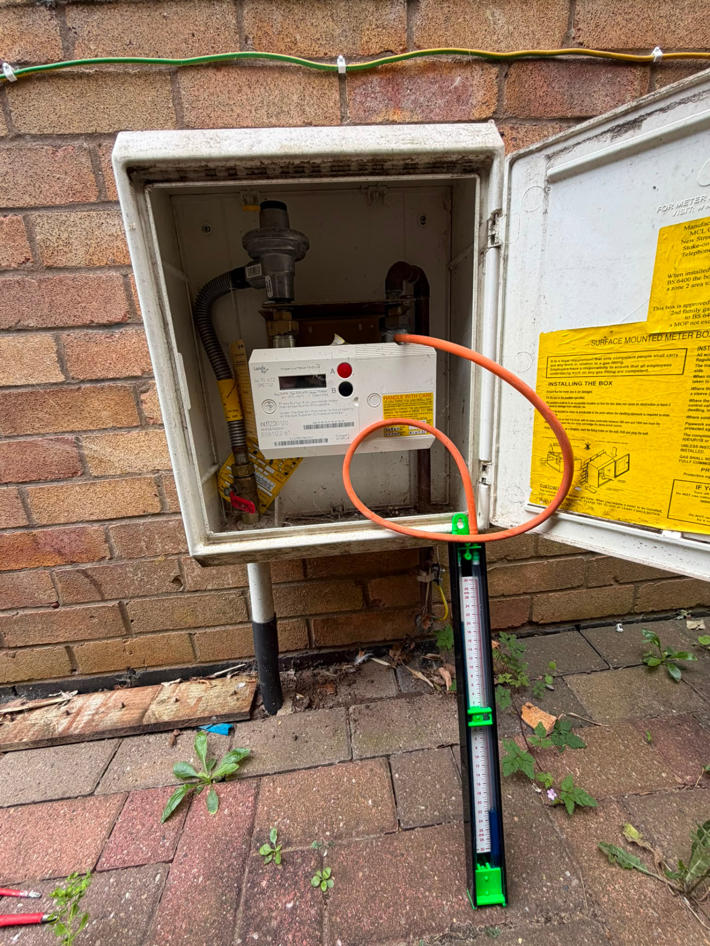 Gas tightness test at external meter box using manometer during Gas Safe safety check, Coventry